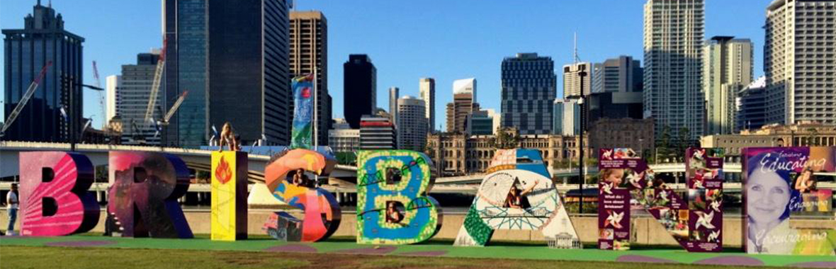 Large letters spelling out Brisbane in front of the city