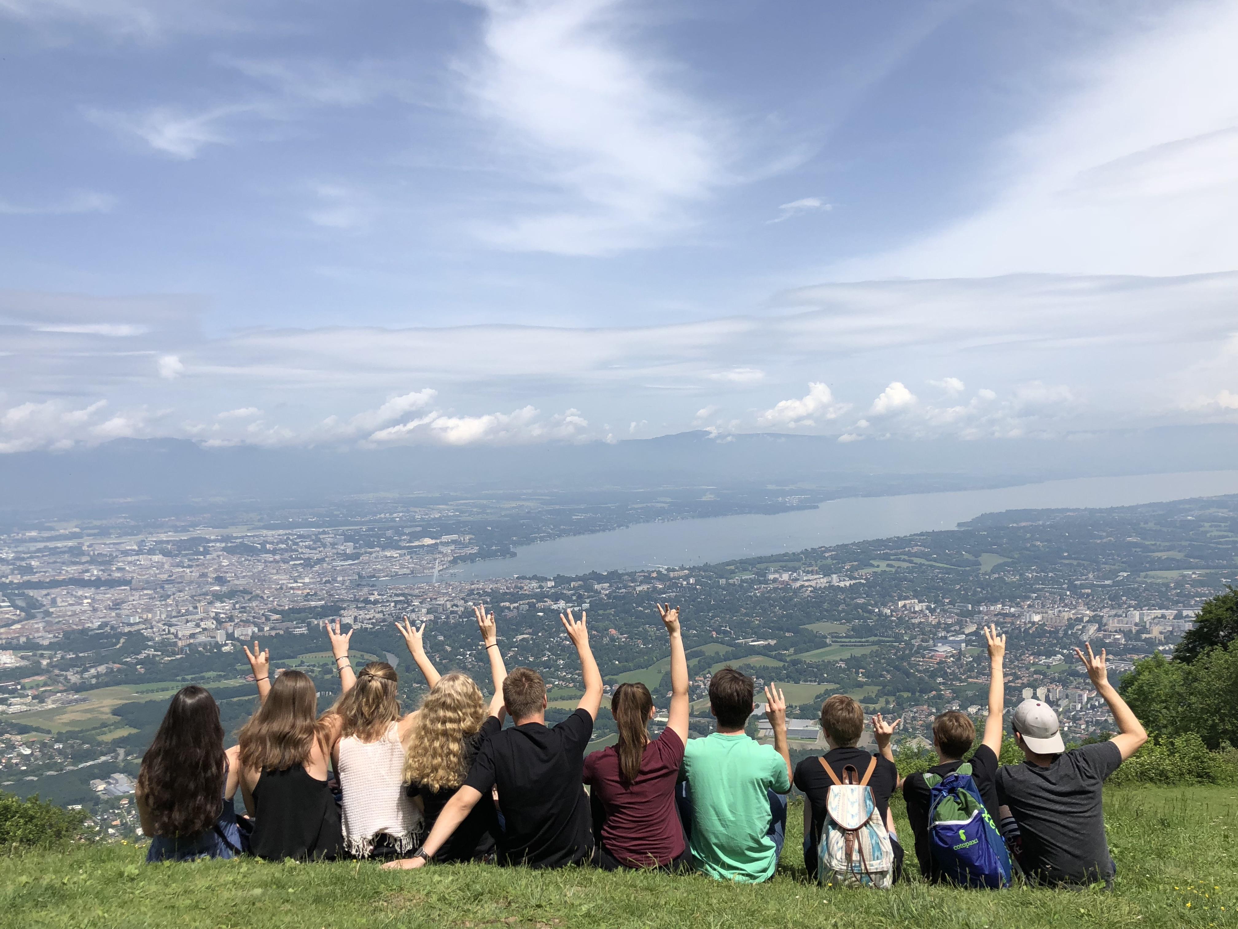 students photographed from the back overlooking mountain landscape